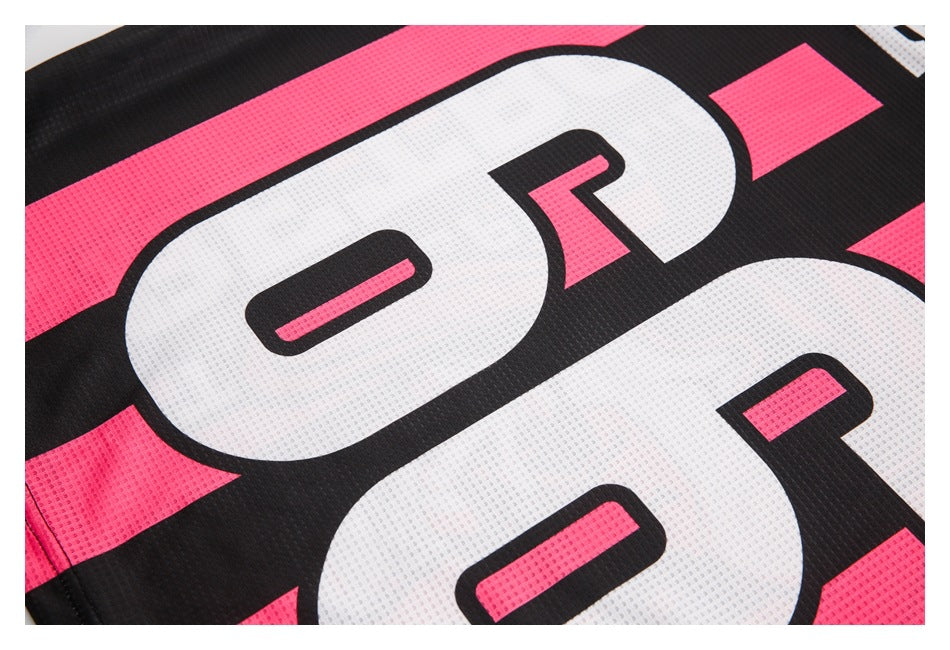 Close-up of oversized white numerals printed on black and bright pink perforated jersey fabric.