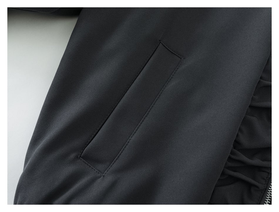 Close-up of a vertical welt pocket on the jacket's sleeve area.