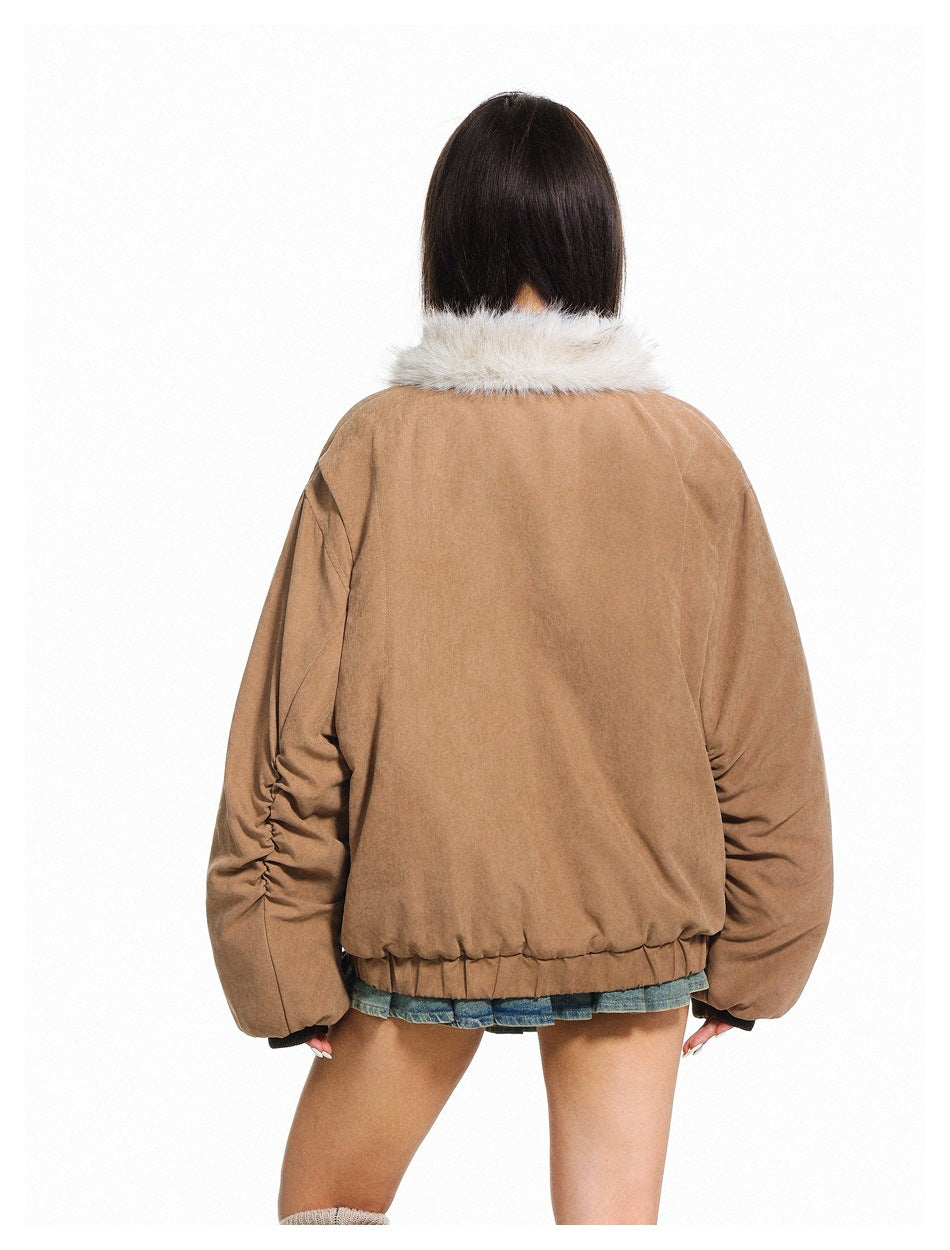 Back view of a model wearing a camel-brown jacket with a cream fur collar and gathered hem.