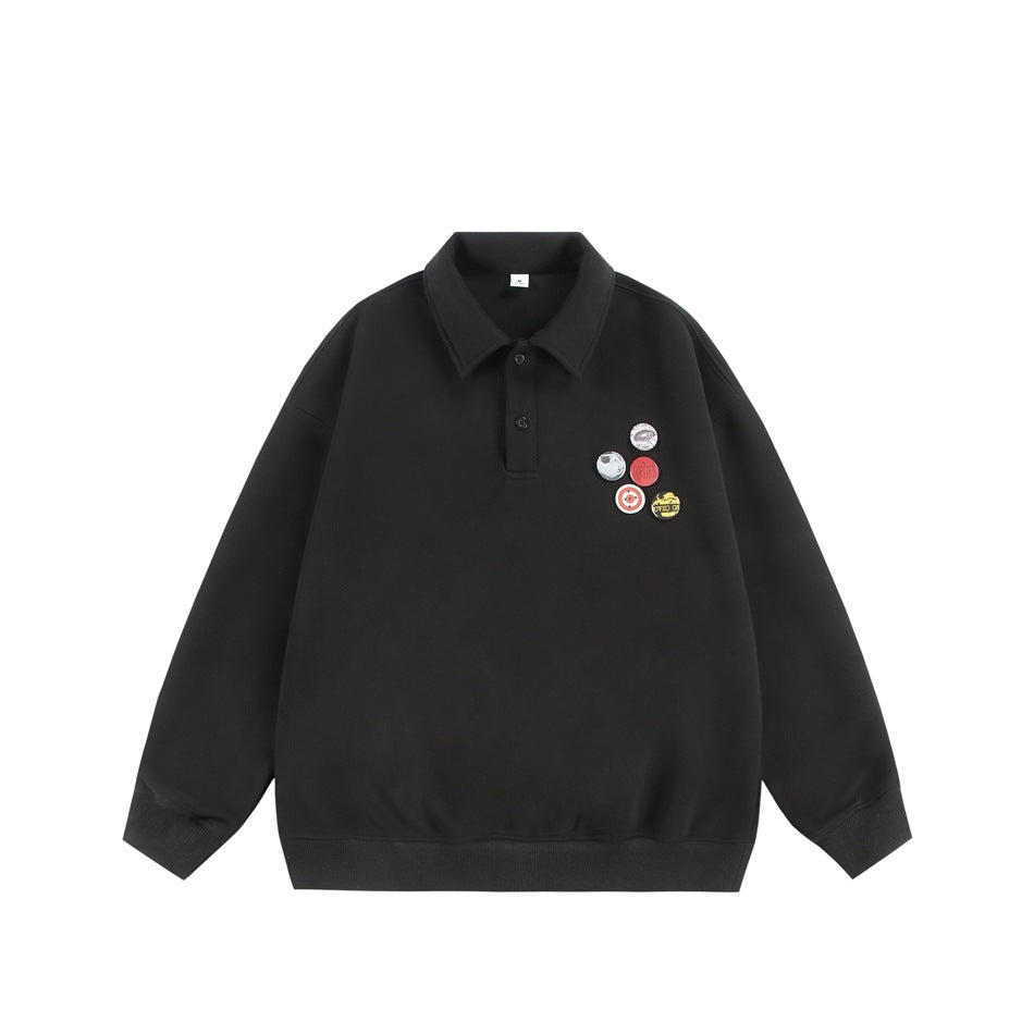 Black polo-collar pullover with two-button placket, ribbed cuffs and hem, and five round badges on the left chest