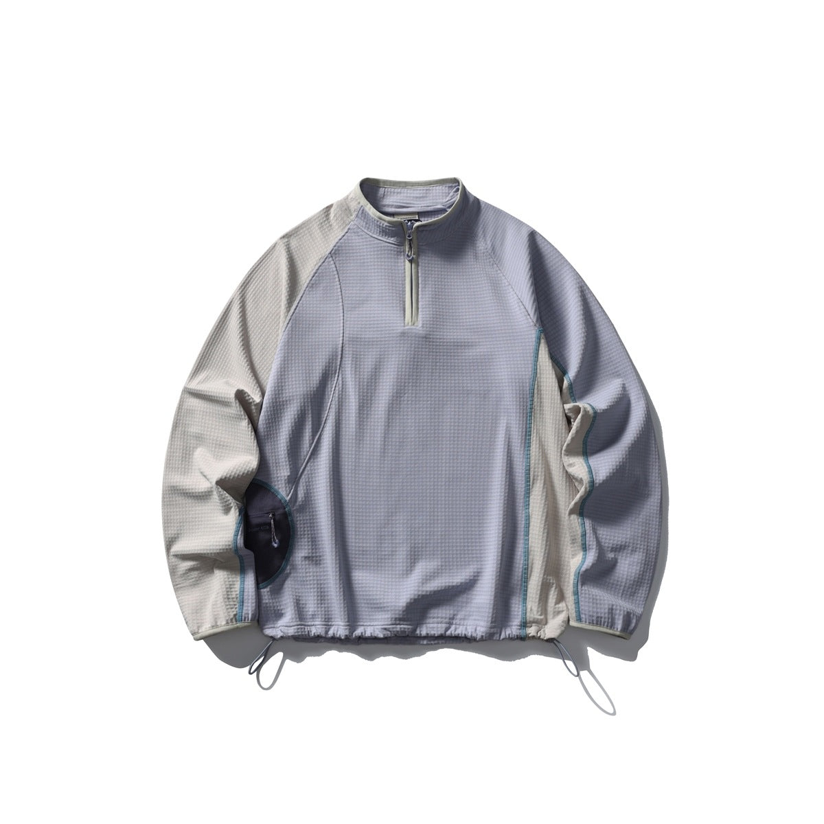 Lavender-gray half-zip pullover with beige raglan sleeves, teal contrast stitching and drawcord hem, flat lay