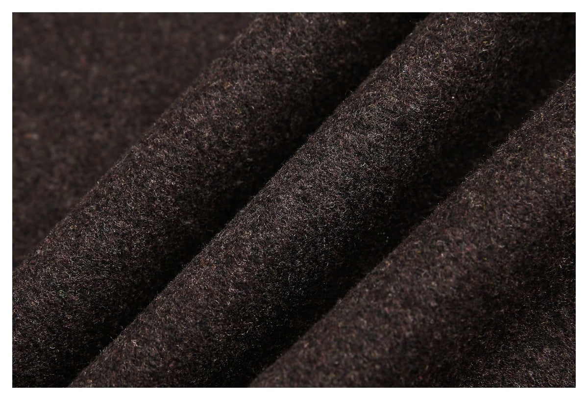 Close-up of dark brown, nearly black fabric with a fuzzy, textured surface and soft folds.