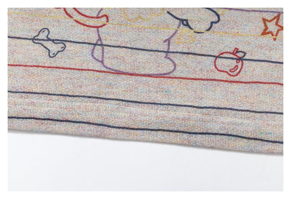 Close-up of a pale multicolor heathered garment with thin colored stripes and outlined doodle prints near the hem.