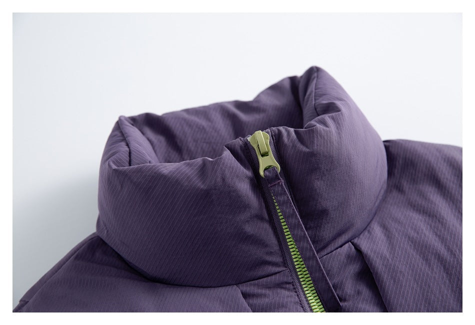 Close-up of the purple jacket's high collar and lime-green zipper with a matching pull.