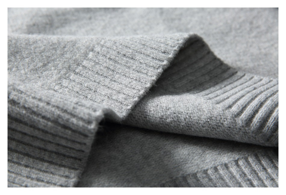 Close-up of ribbed knit edges and soft gray sweater fabric.