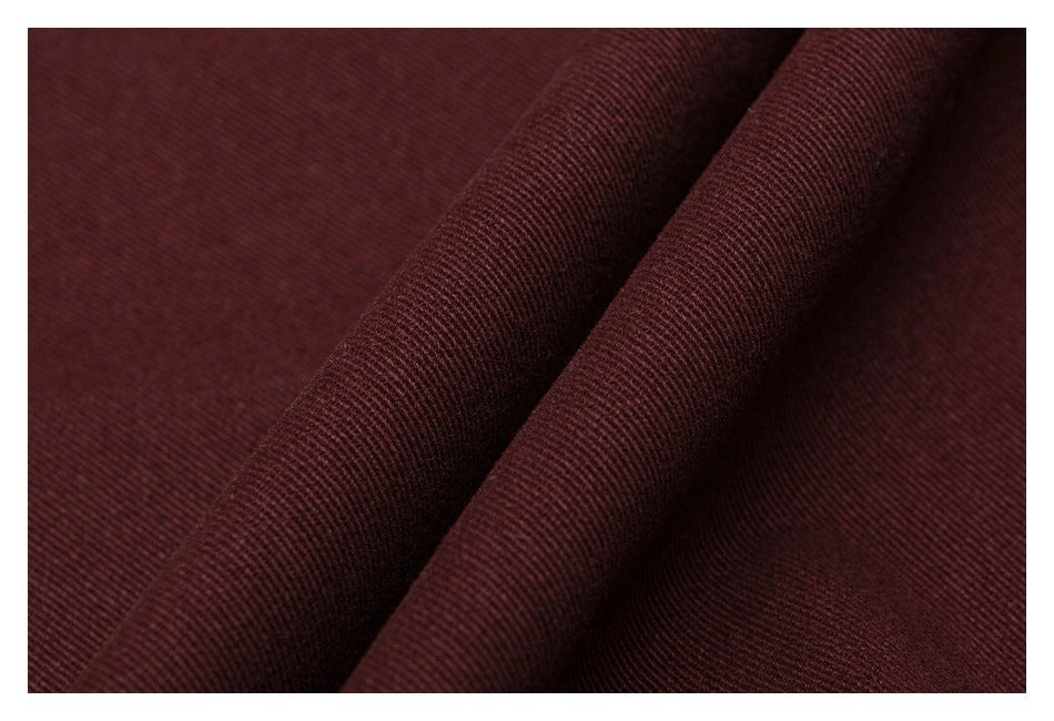 Close-up showing the fine diagonal weave and folds of burgundy fabric.