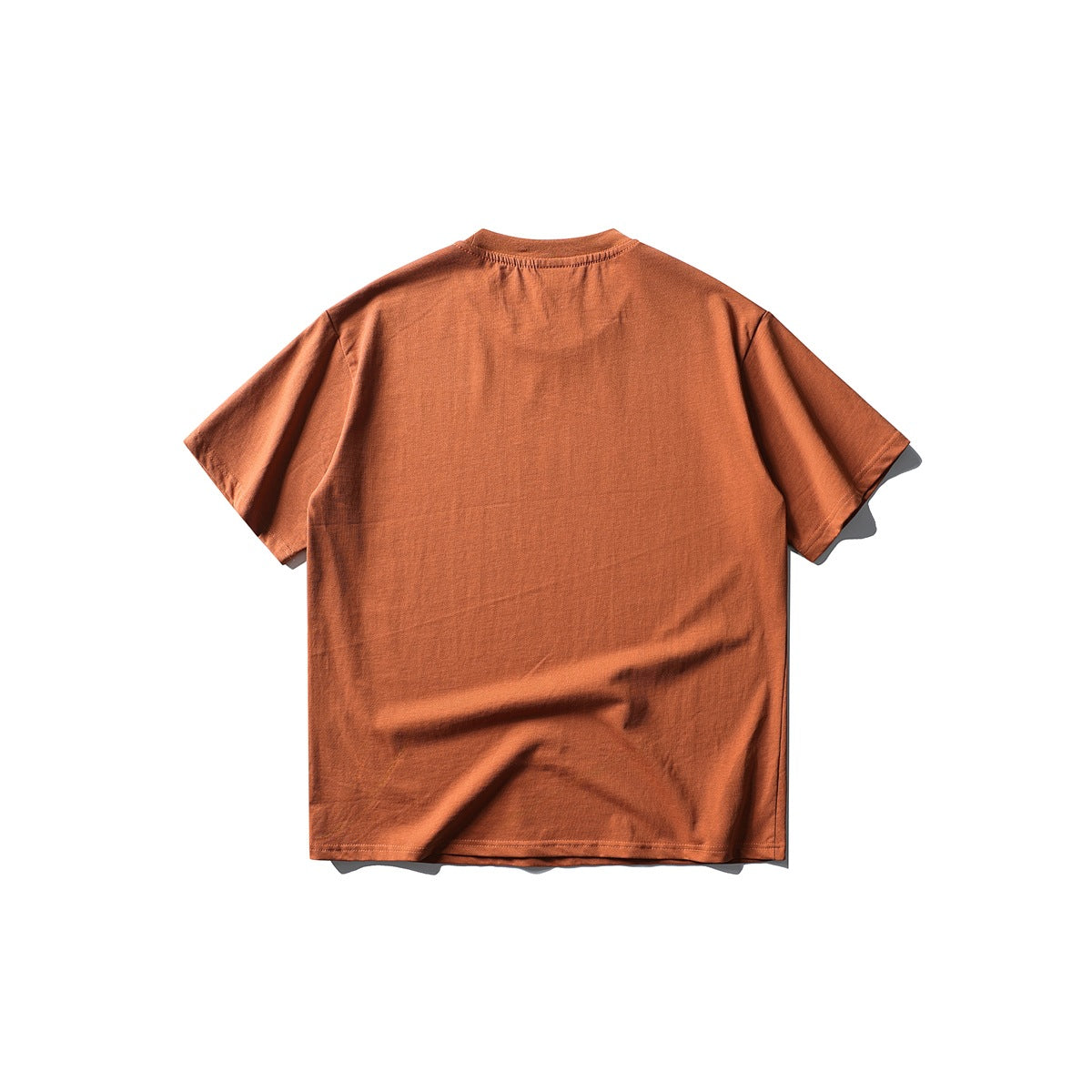 Back view of plain burnt orange short-sleeve crew neck T-shirt, flat lay
