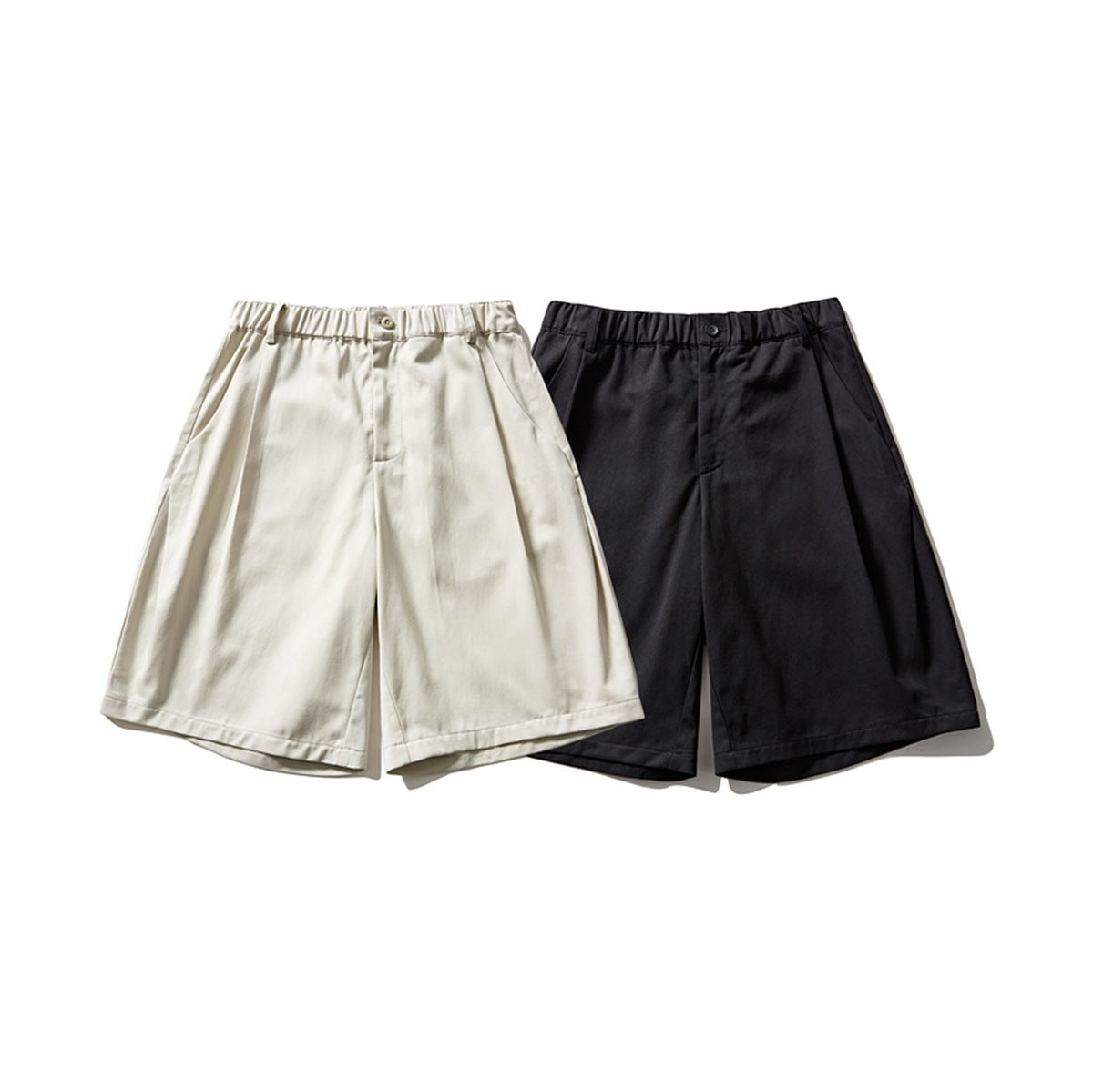 Front view of wide-leg shorts in cream and black, with elasticated waistbands, belt loops and slanted pockets.