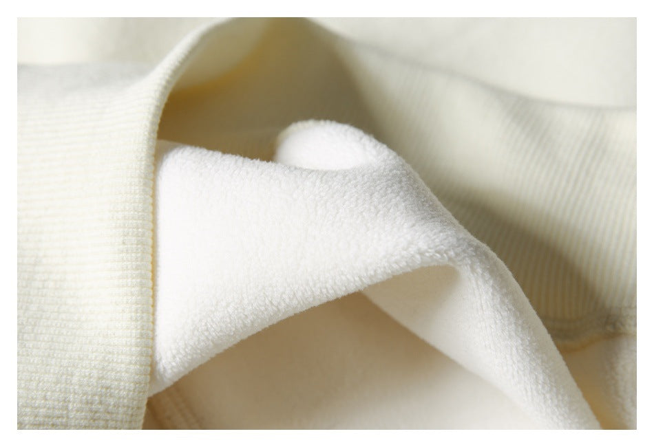 Close-up of ivory fabric showing a plush inner surface beside a ribbed edge.
