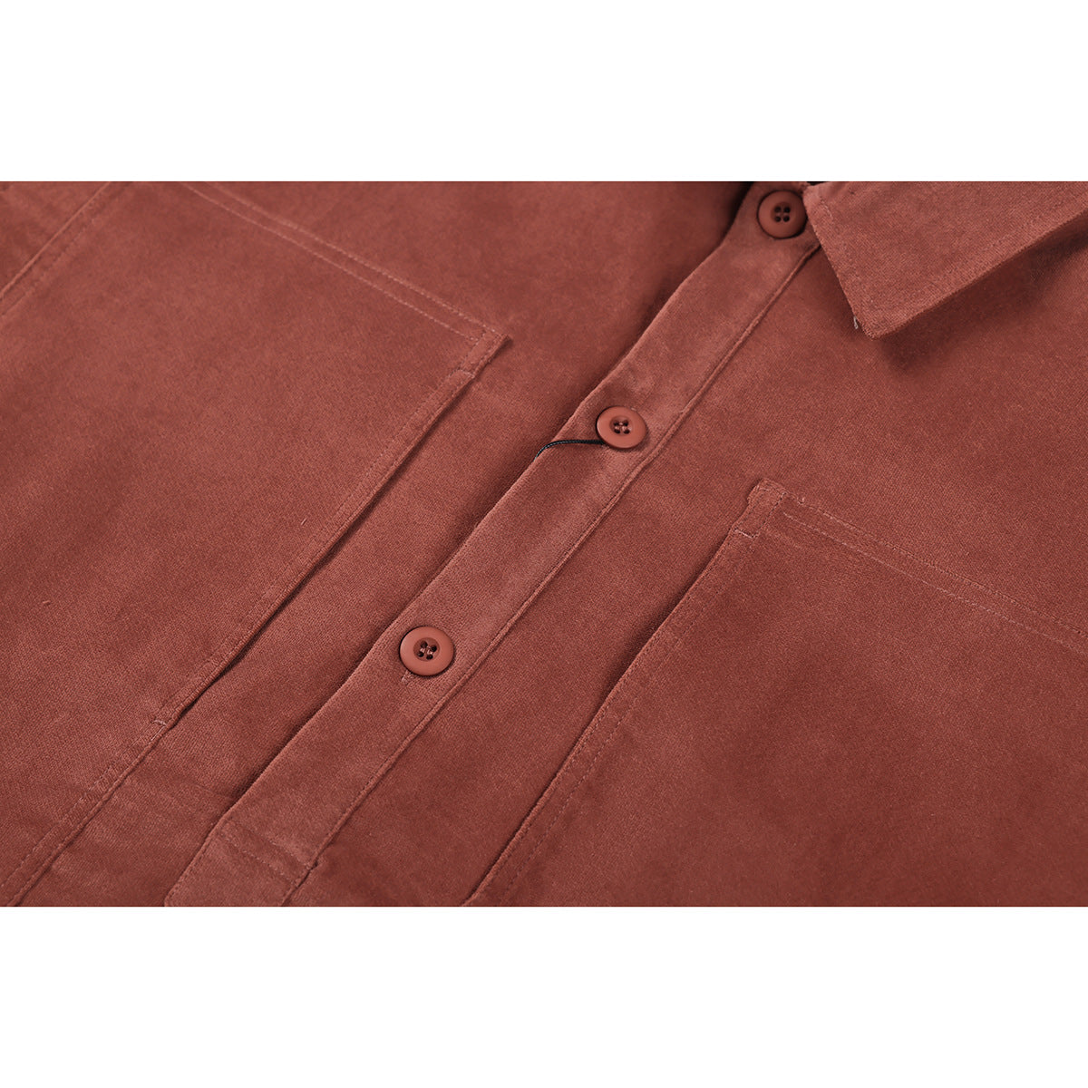 Close-up of the rust-brown shirt's button placket and two chest pockets.