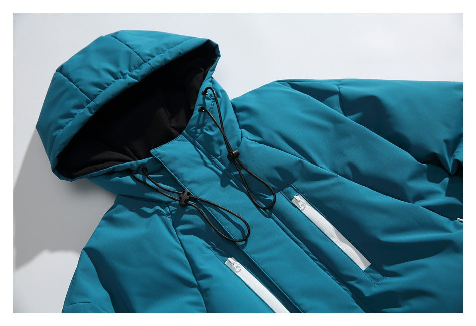 Upper front of a teal jacket showing its black-lined hood, drawcords and white zip pockets.