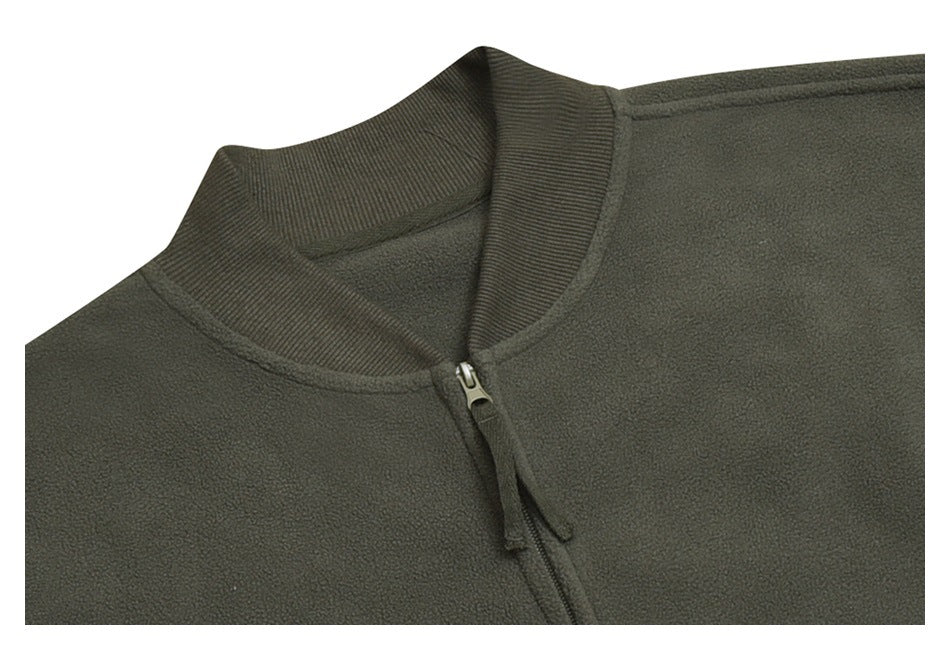 Close-up of the olive-gray jacket's ribbed stand collar and front zipper.
