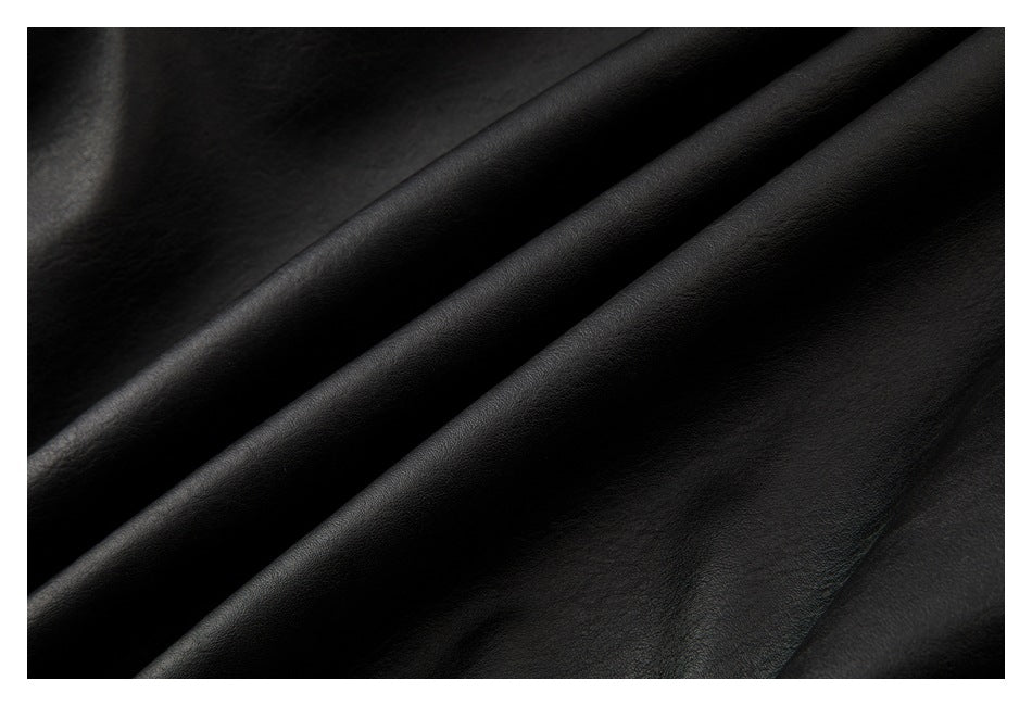 Close-up of the black jacket's subtly textured surface draped into soft folds.