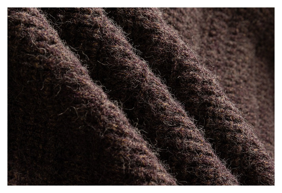 Macro view showing the fuzzy, chunky knit texture of dark brown fabric.