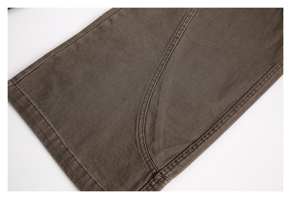 Close-up of a brown trouser leg and stitched hem laid flat on a white background.