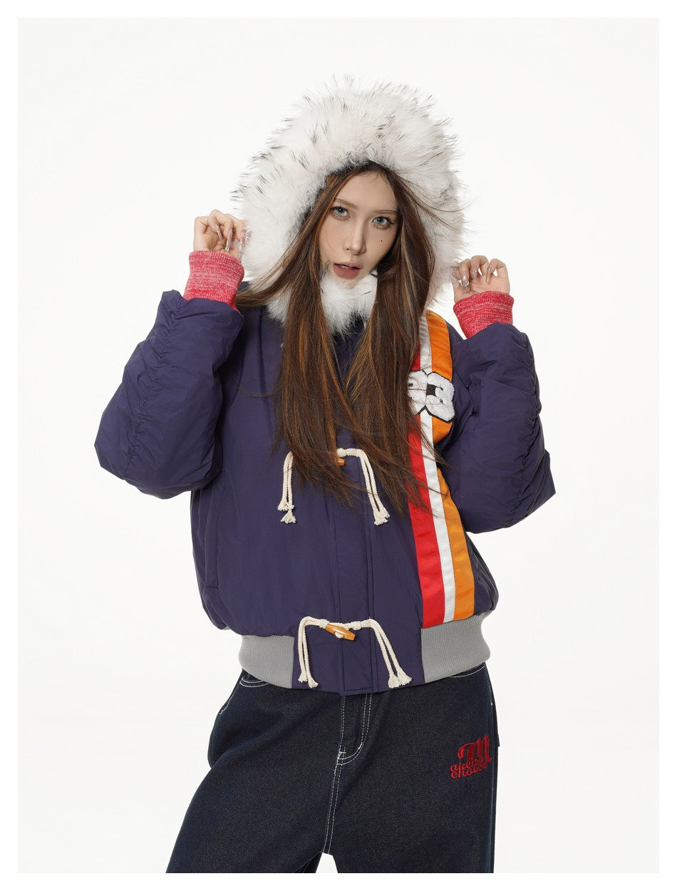 Model wearing the jacket with the white fluffy hood up, showing toggle ropes, stripe, gray ribbed hem and red cuffs