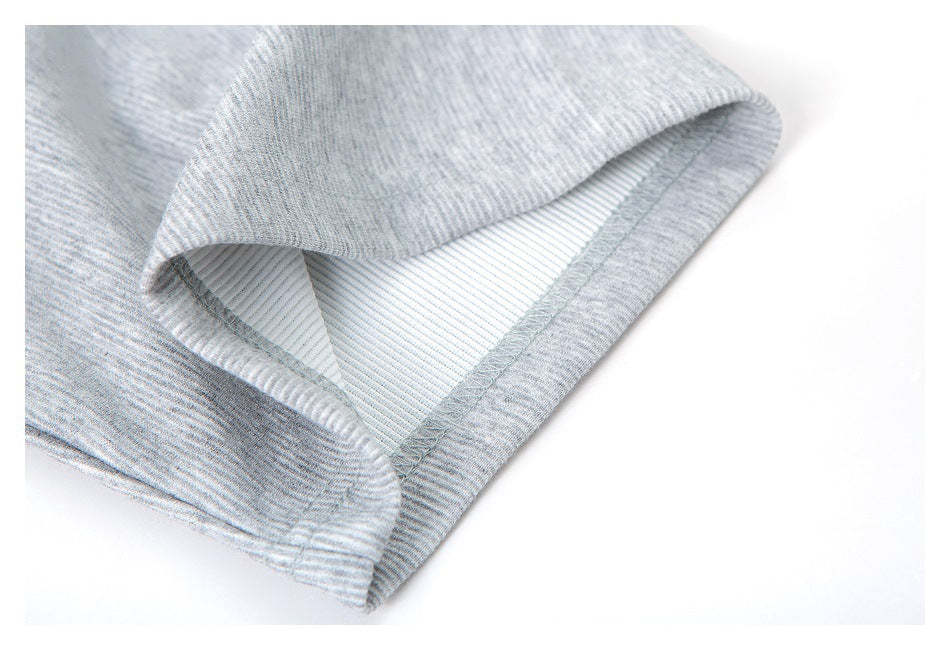 Close-up of a heather gray shirt sleeve opening, showing the inside seam and stitching.