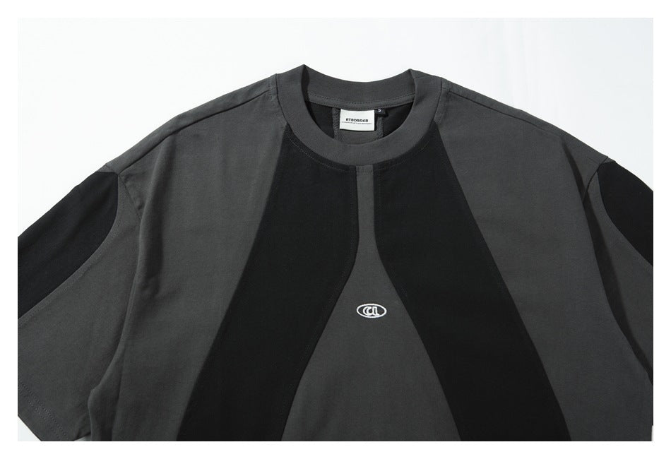 Front view of a charcoal and black color-block short-sleeve T-shirt with a crew neck and small white chest emblem.