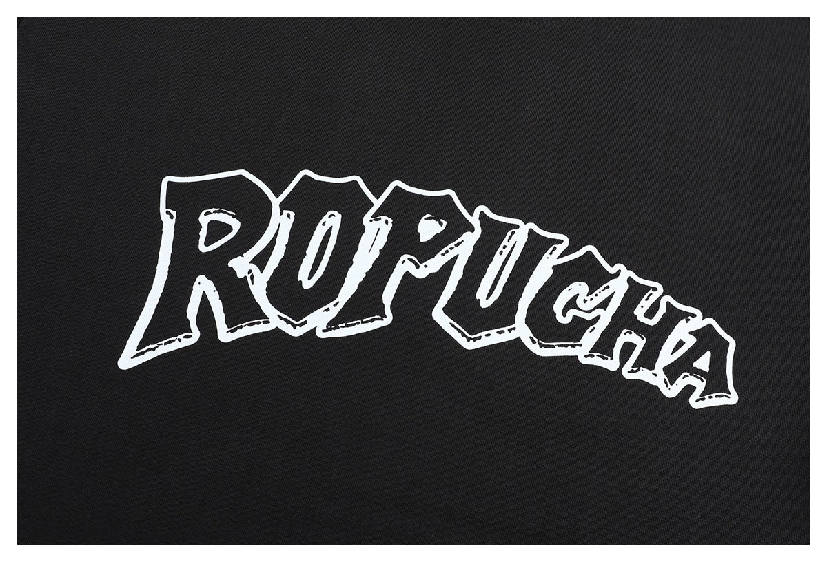 Close-up of the T-shirt's large white outlined lettering printed across black fabric.