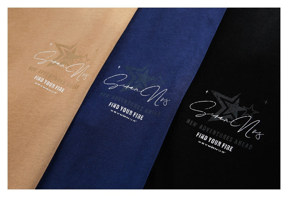 Camel-brown, navy, and black T-shirts displayed together with matching white script and star graphics.