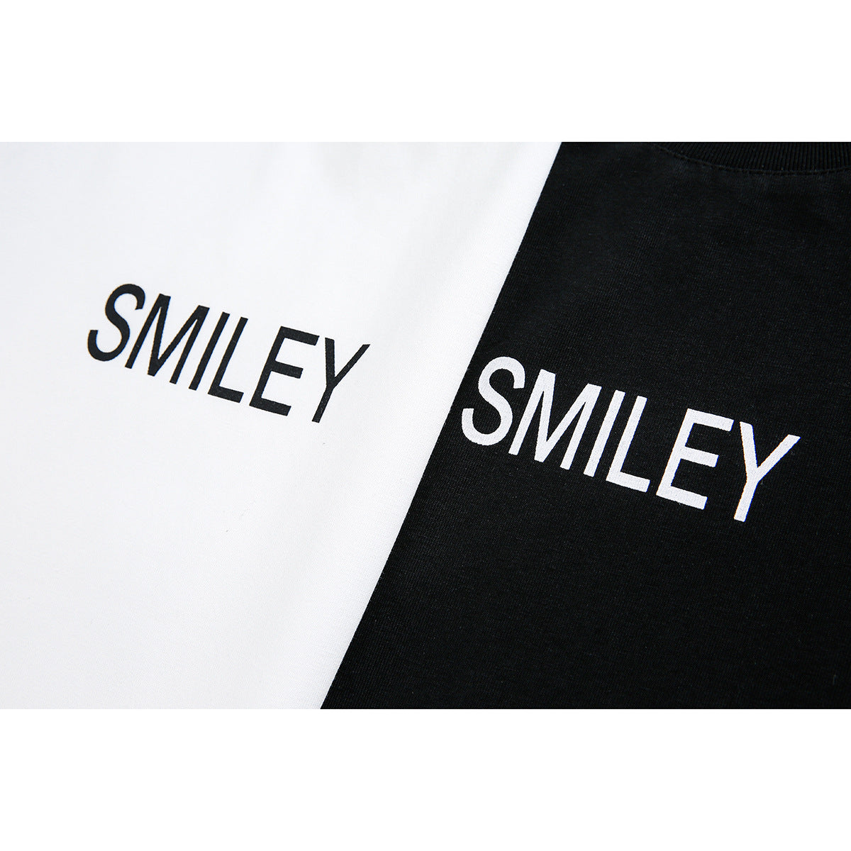 Close-up of white and black tops with contrasting SMILEY lettering printed across the chest.