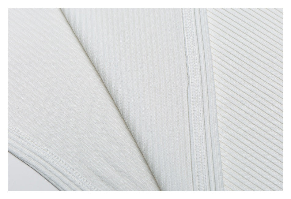 Close-up of white ribbed knit fabric showing interior stitching and finished seams.