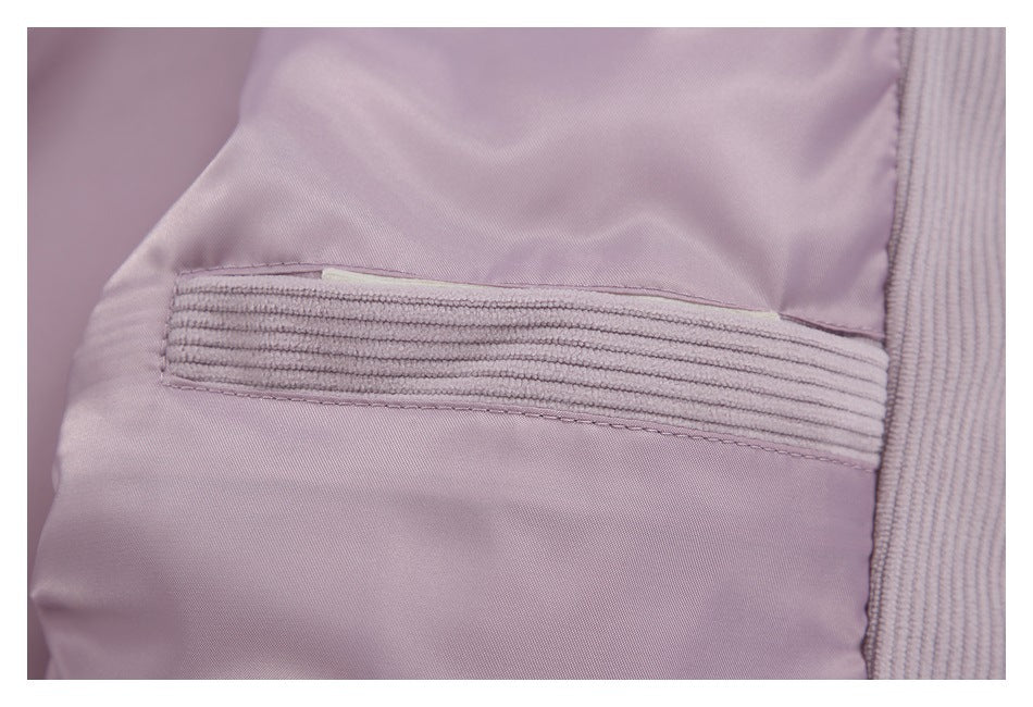 Close-up of a pale mauve jacket interior pocket with a ribbed corduroy edge.