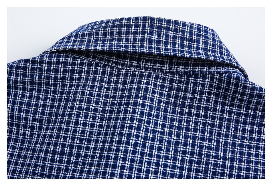 Close view of the back collar and upper back of a navy and white plaid shirt.