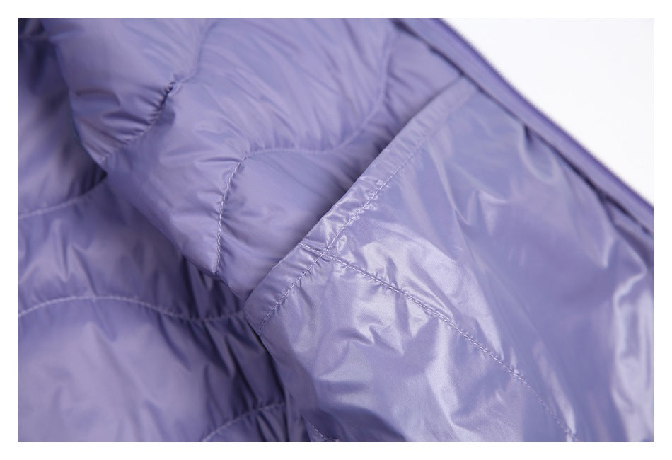 Close-up of shiny lavender lining with curved quilted stitching.