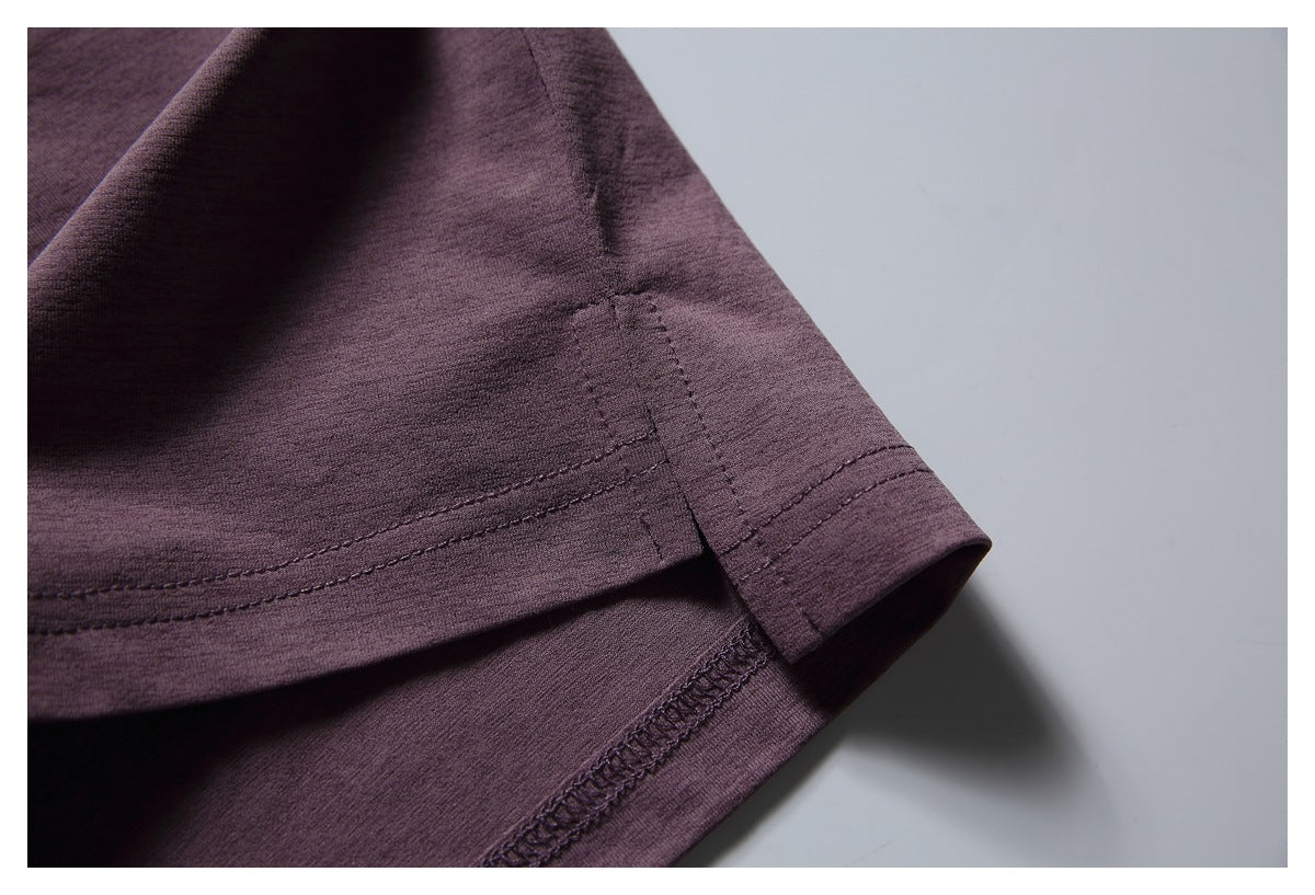 Close-up of the plum T-shirt's sleeve edge and double-stitched hem.
