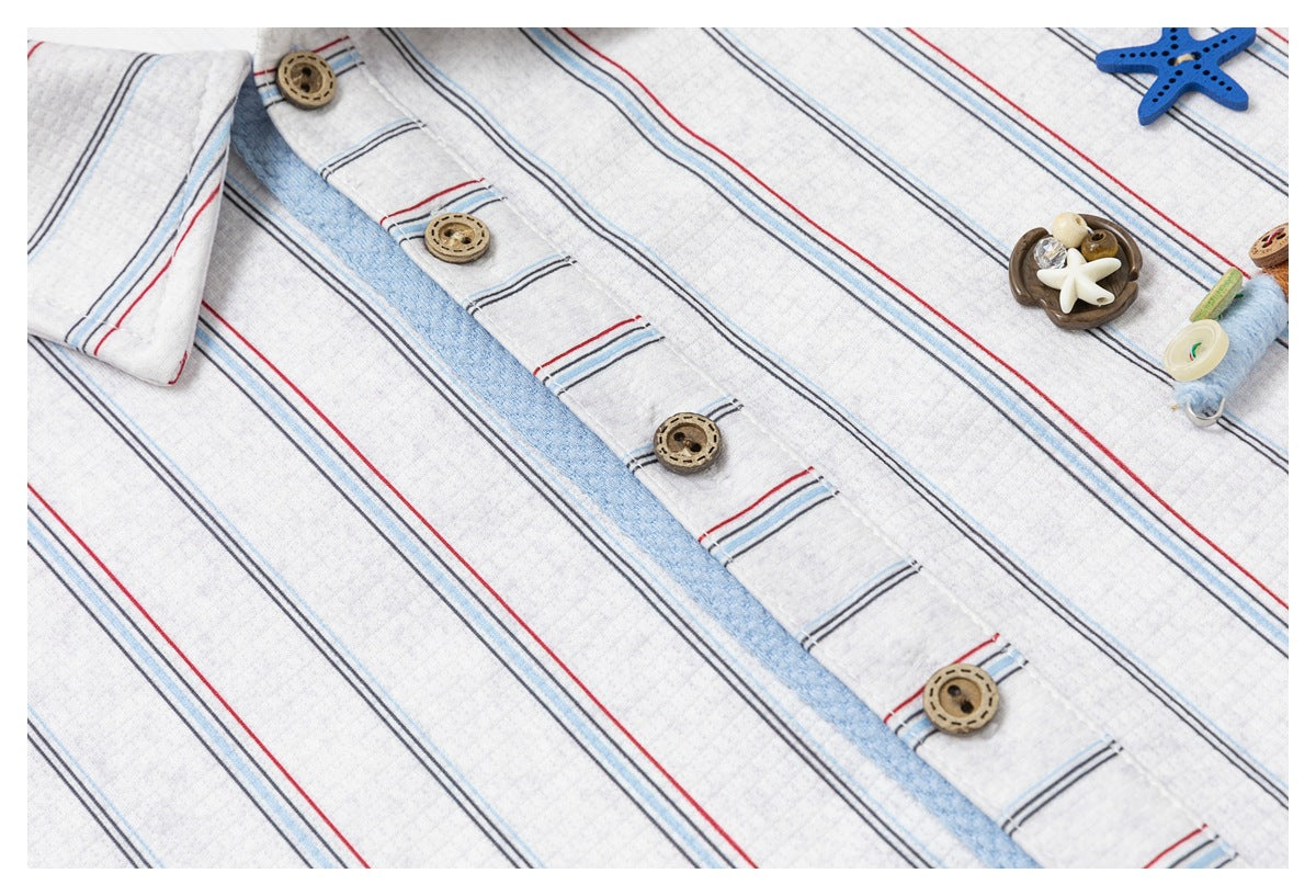 Close-up of the striped shirt's button placket and decorative star and shell charms.