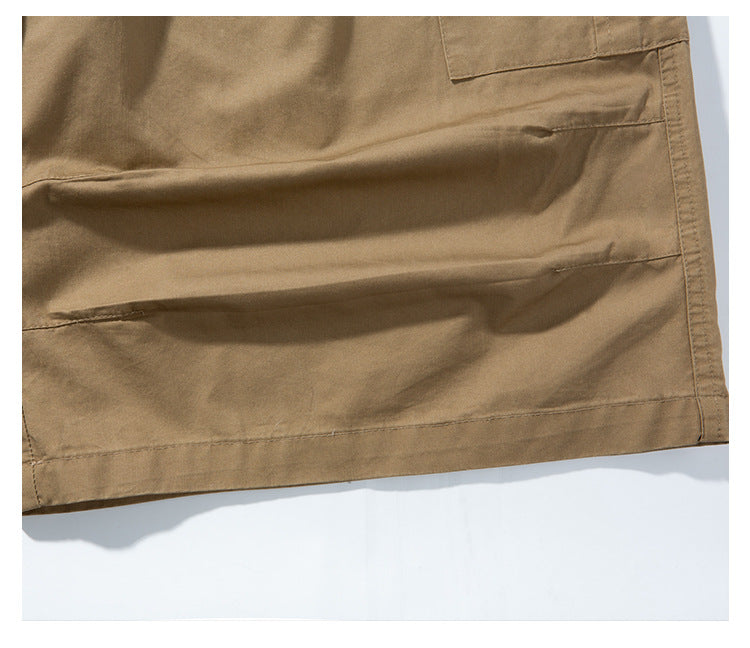 Close-up of the tan pants leg showing the stitched hem and fabric folds.