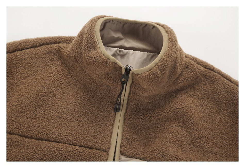 Close-up of a brown textured fleece jacket collar and front zipper with tan trim and lining.