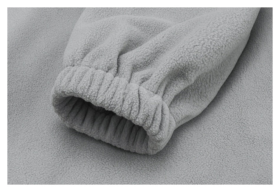Close-up of a light gray fleece sleeve with a gathered ribbed cuff.