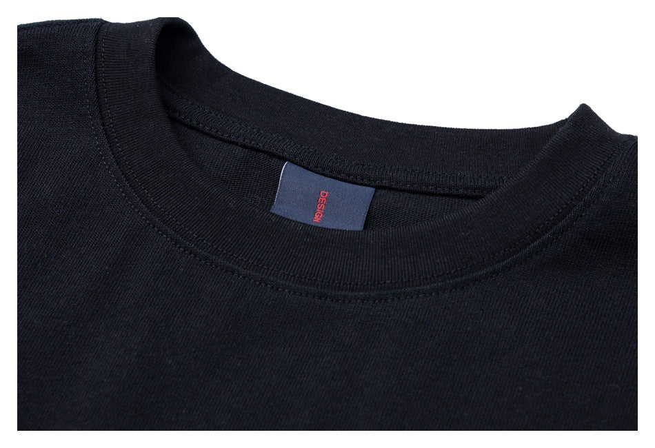 Close-up of a black crew-neck shirt collar and inner label.