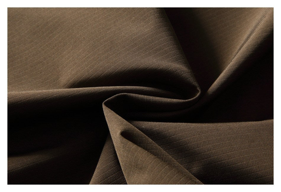 Close-up of brown fabric arranged in folds, showing its fine woven surface.