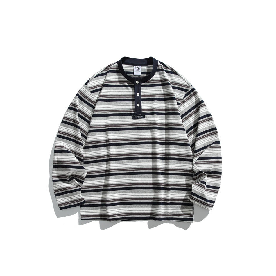 Navy striped long-sleeve henley-style top with gray, white and brown stripes, flat lay front view