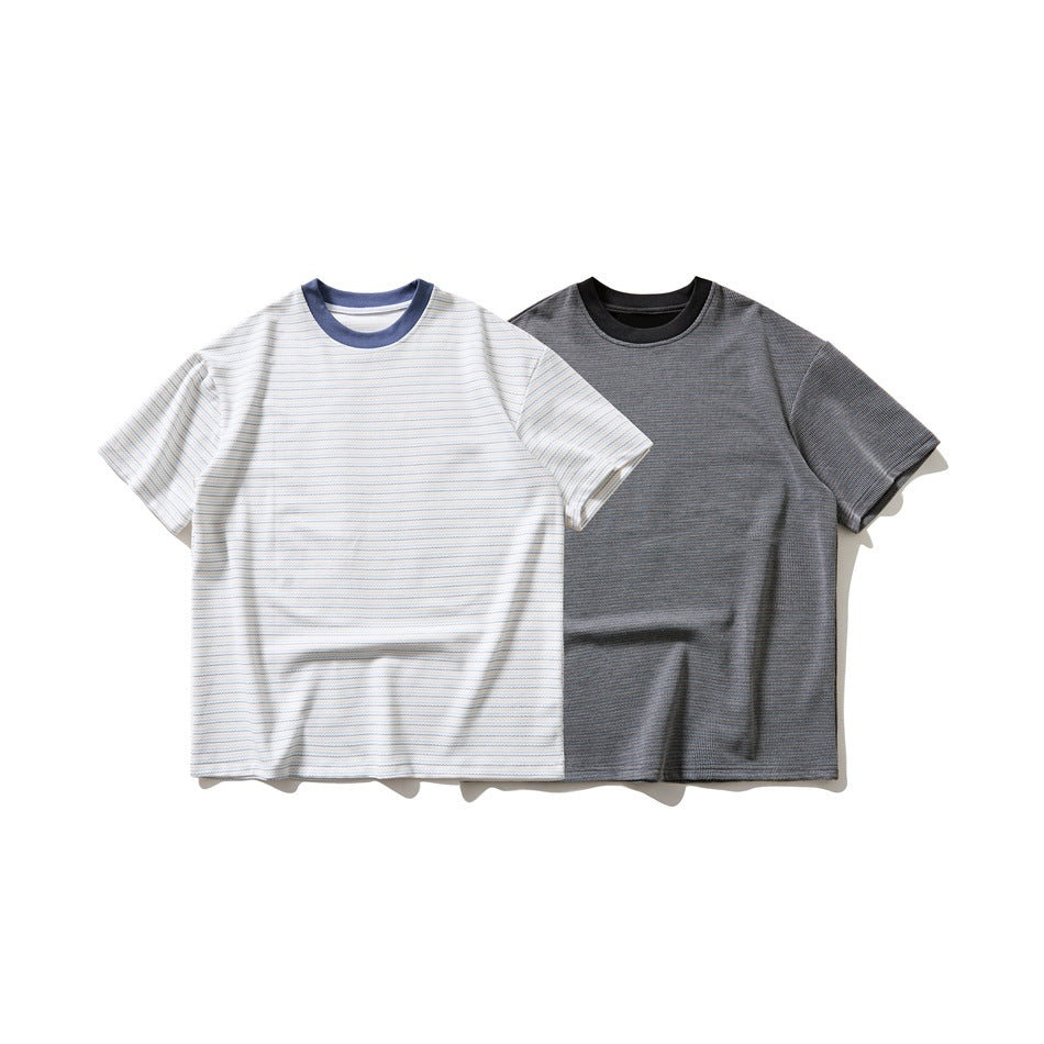 Two short-sleeve crew-neck T-shirts shown from the front: one white with fine stripes and one charcoal gray.