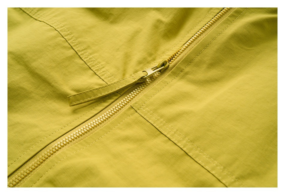 Close-up of a mustard-yellow zipper and stitched panels.