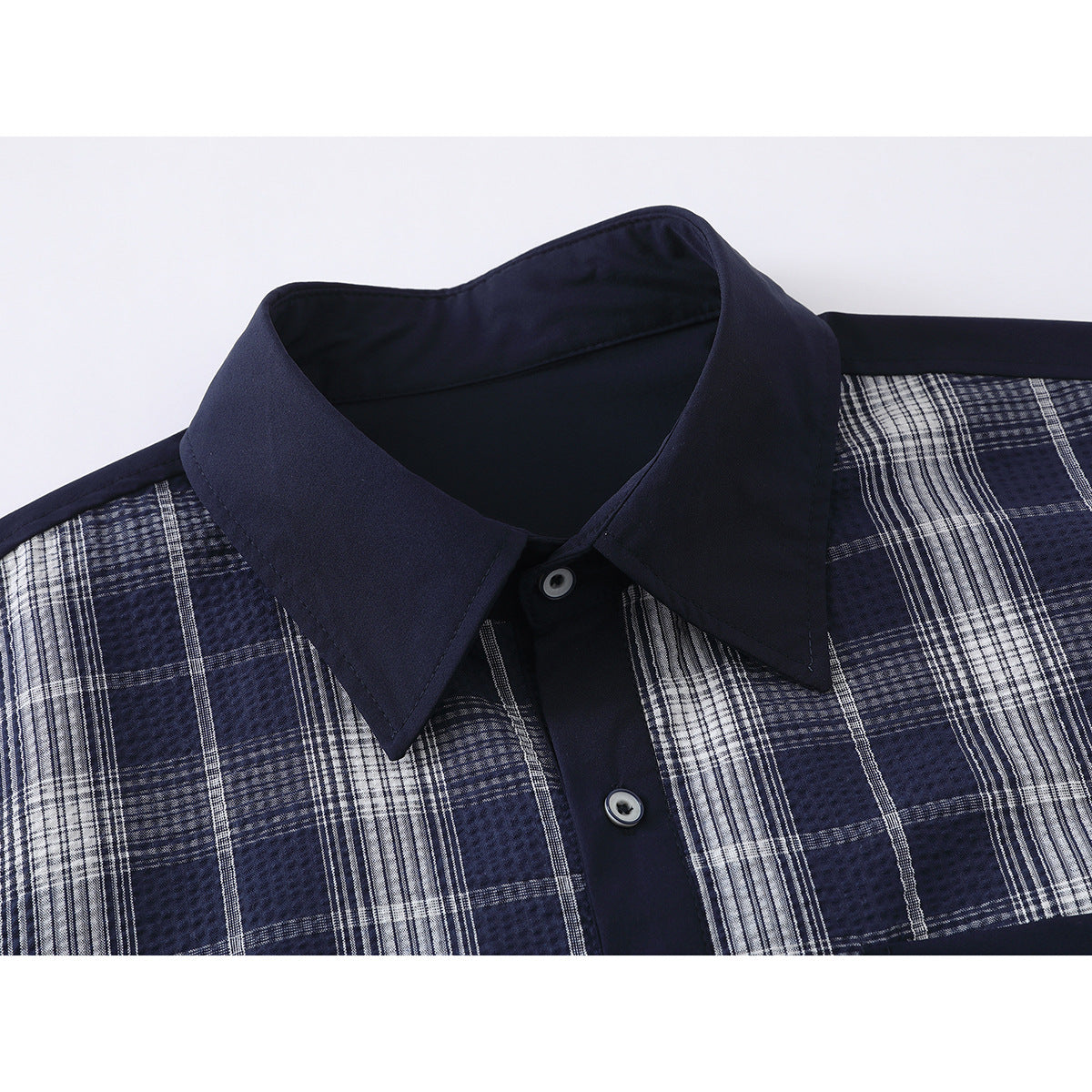 Close-up of a navy shirt collar, button placket, and blue-and-white plaid front.