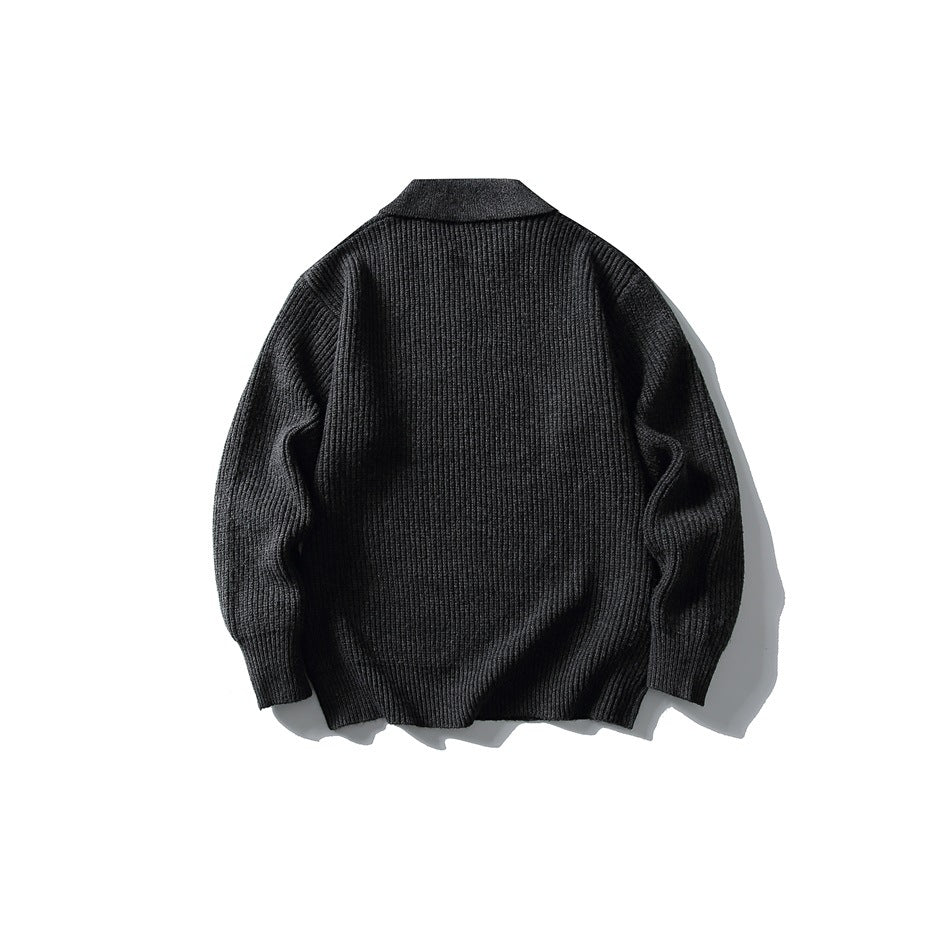 Back view of dark gray ribbed knit sweater with folded collar and ribbed cuffs, flat lay