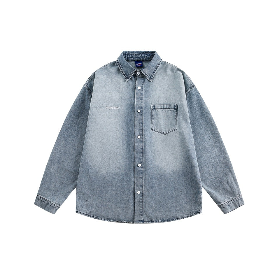 Faded blue denim shirt flat lay with pointed collar, button front, chest pocket and buttoned cuffs