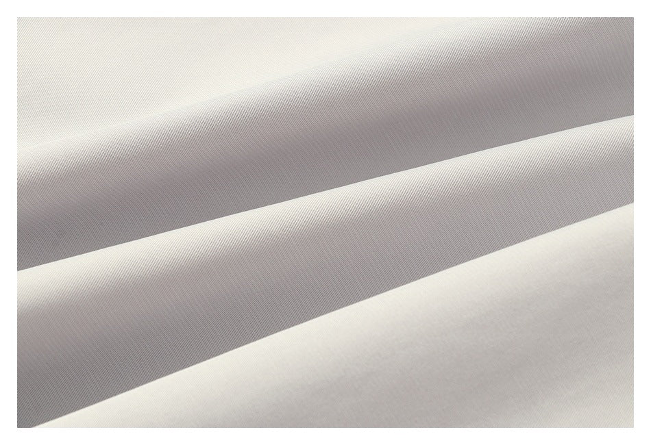 Close-up of the fine diagonal weave on light gray fabric.