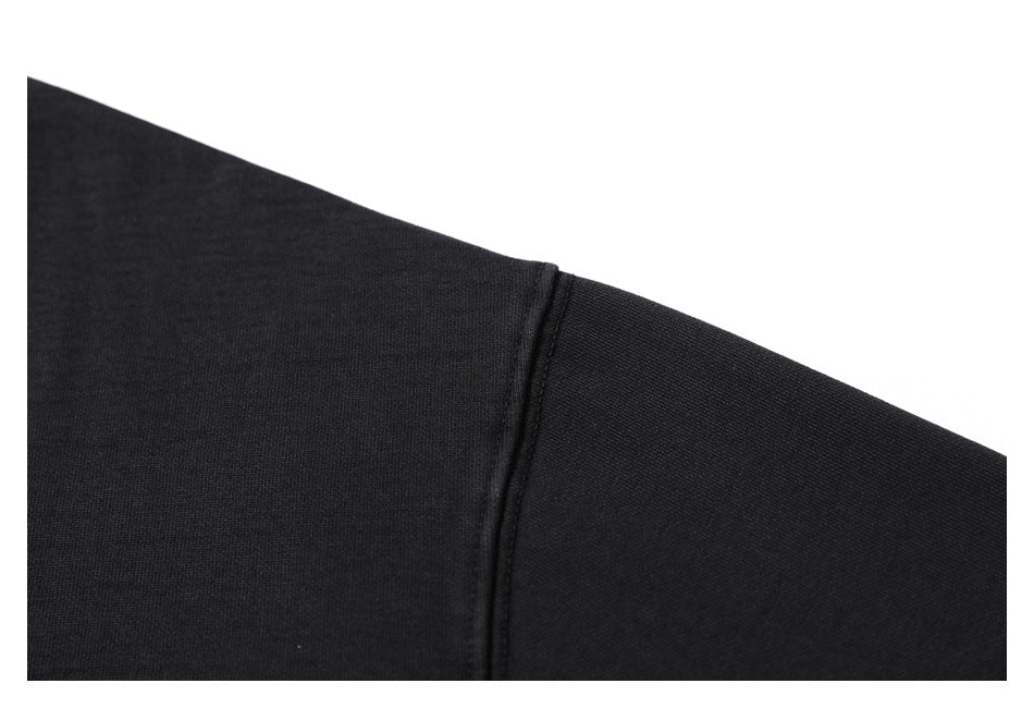 Close-up of a black sleeve showing a stitched seam.