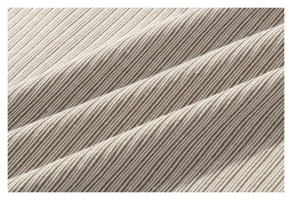 Close-up of beige and brown striped fabric in diagonal folds.