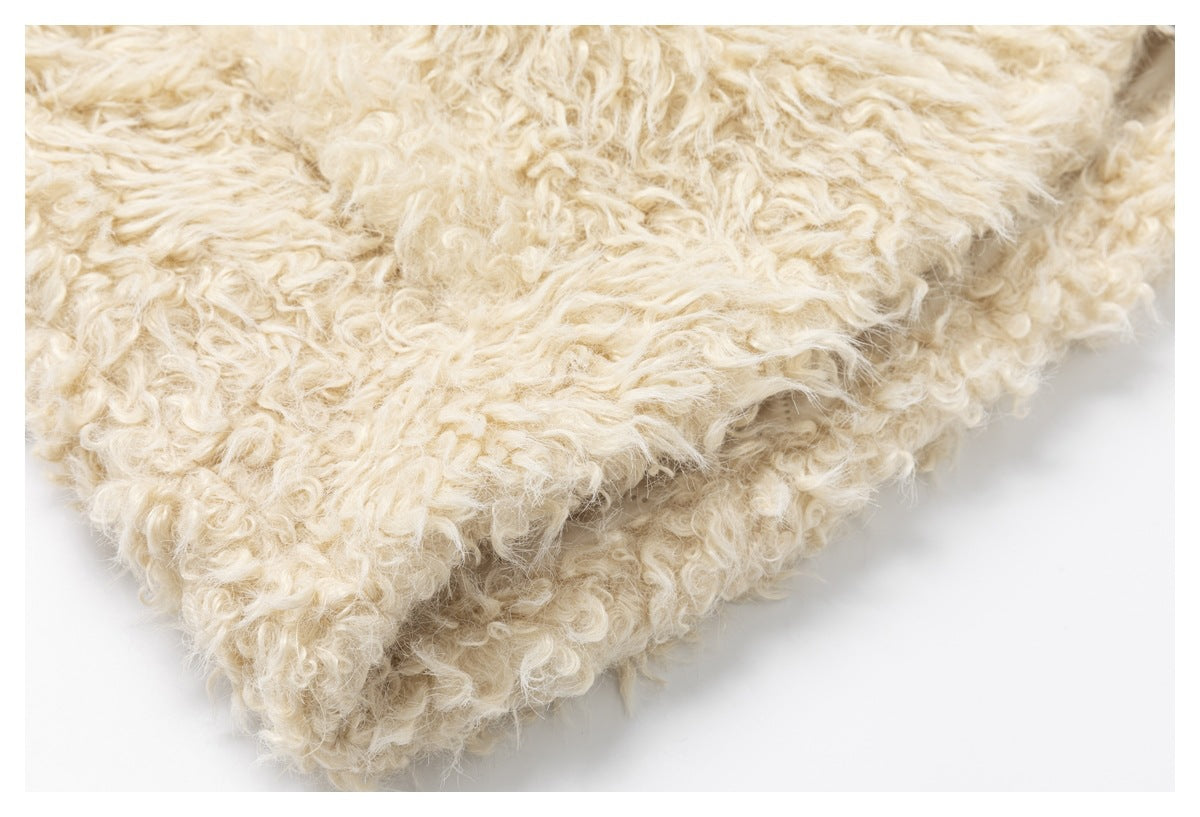 Close-up of the garment's dense, curly cream-colored pile.