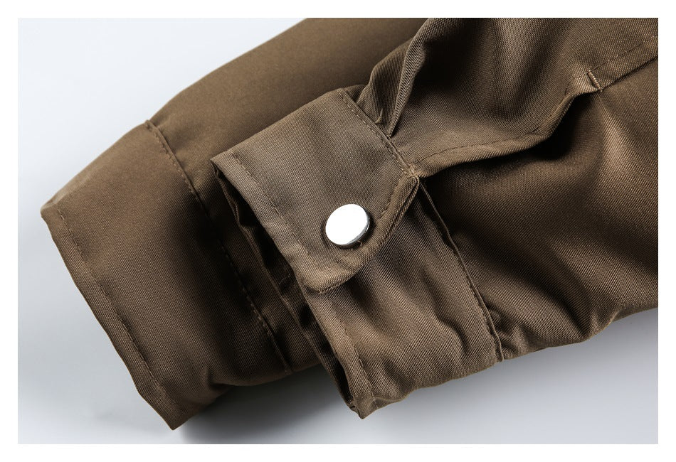 Close-up of a brown sleeve cuff with a snap-button tab and stitched seams.