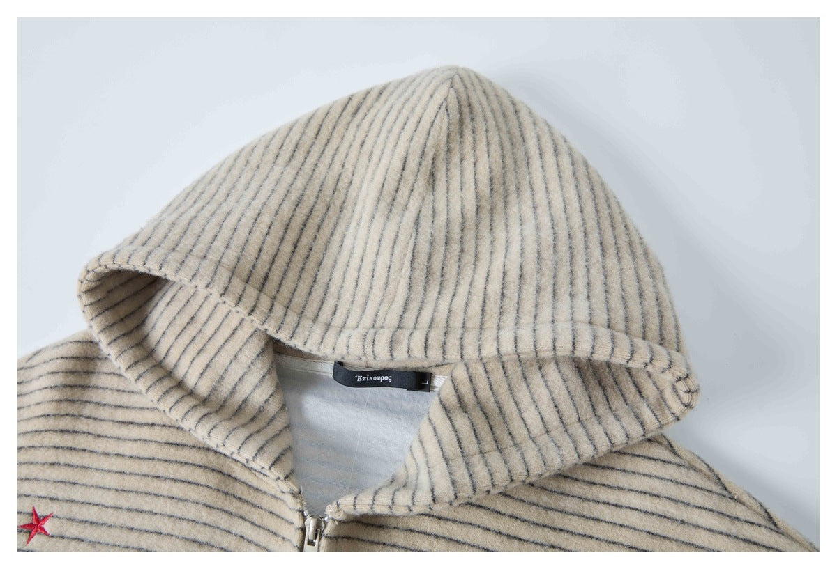 Close-up of the beige jacket's striped hood, zipper, and neck label.
