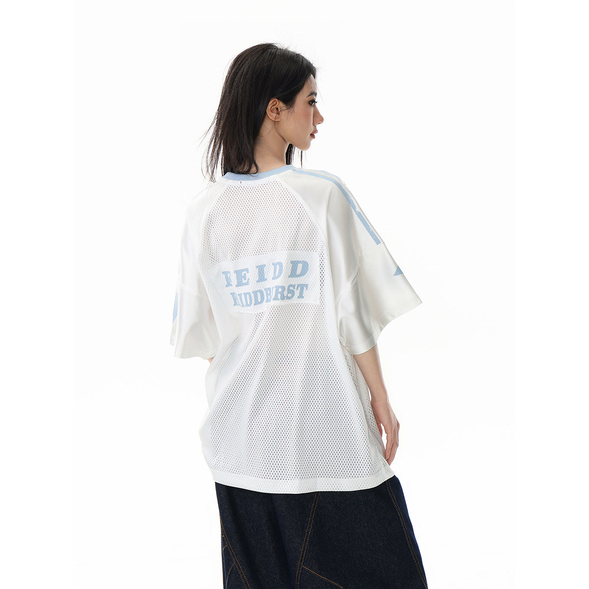 Model showing the back of a white mesh jersey with pale blue trim and lettering.
