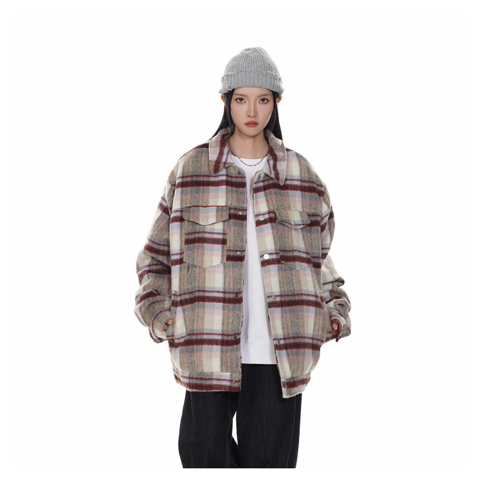 Front view of a model wearing a cream, gray, and red plaid button-front jacket with flap chest pockets.